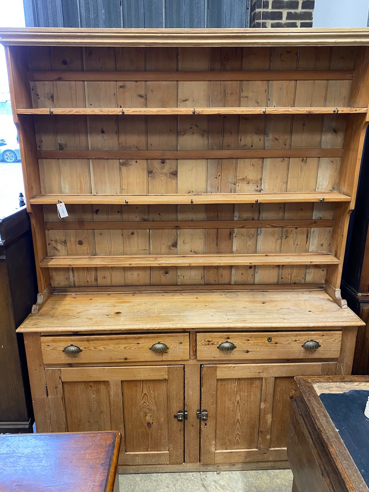 A Victorian pine dresser with boarded rack, length 173cm, depth 44cm, height 230cm